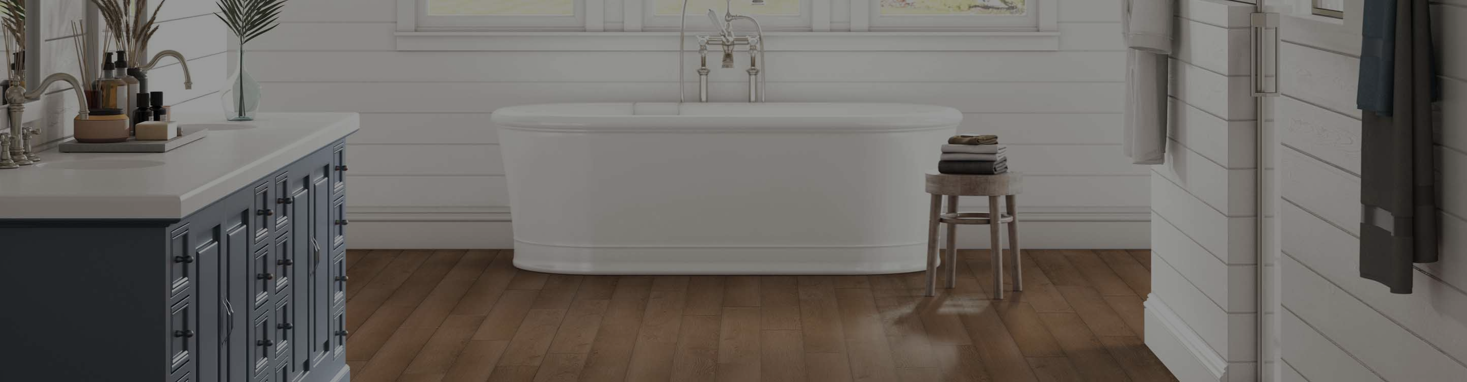 hardwood flooring in bathroom with soaker tub