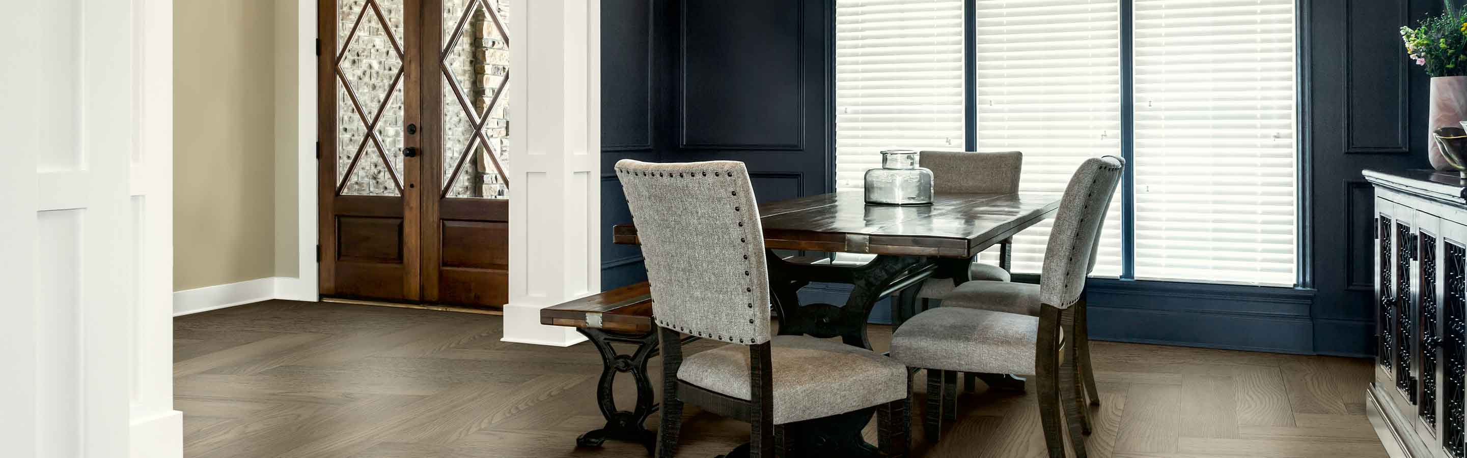 dining room and entryway with large window and blinds